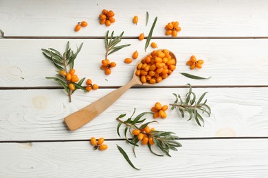 Flat lay composition with ripe sea buckthorn on white wooden table