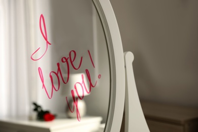 Photo of Words I Love You written on mirror indoors