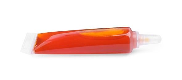 Photo of Tube with orange food coloring on white background