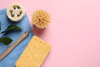 Photo of Flat lay composition with sponge and other bath supplies on pink background. Space for text