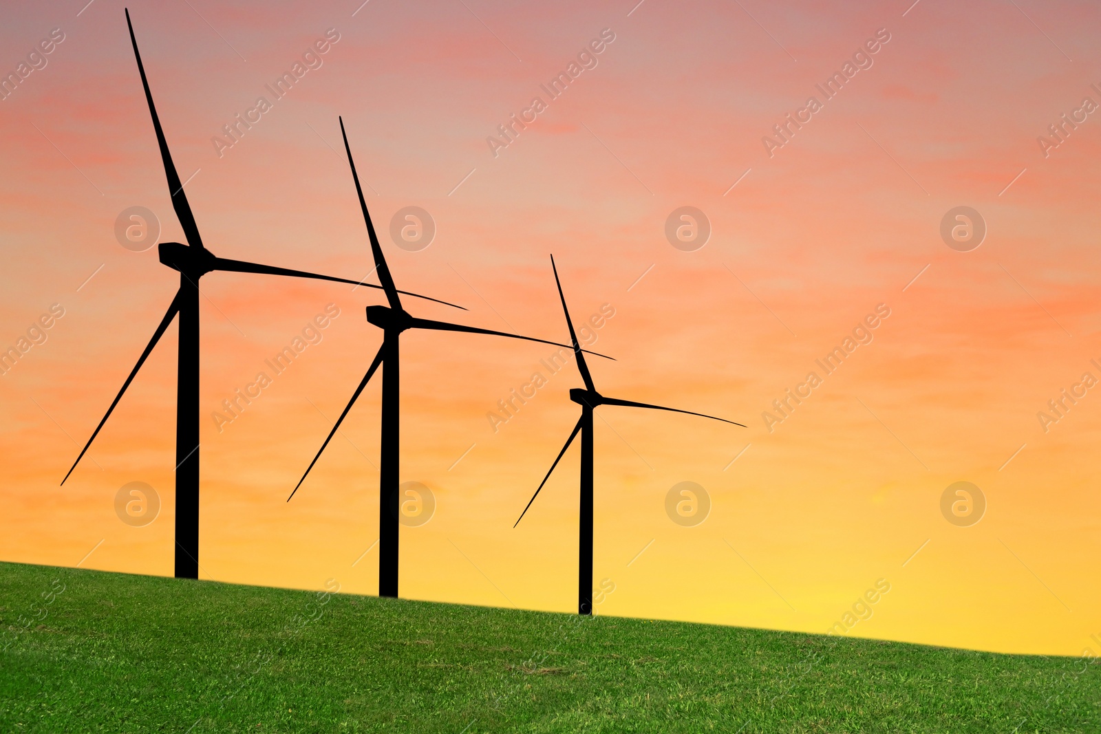 Image of Silhouettes of wind turbines at sunset. Alternative energy source