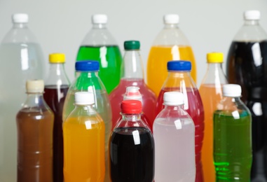 Photo of Bottles of soft drinks on grey background