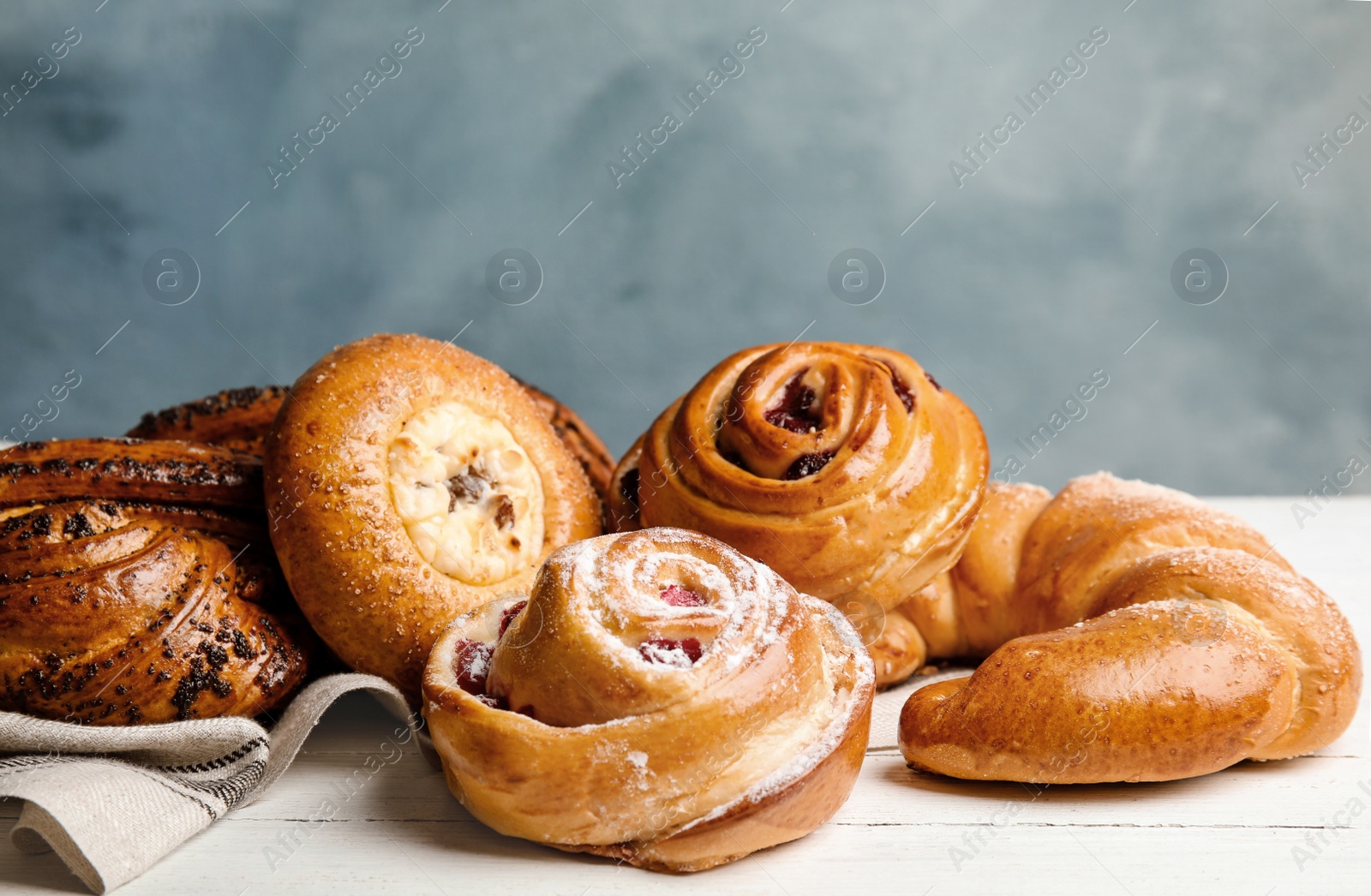 Photo of Different delicious fresh pastries on white wooden table