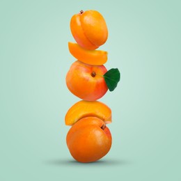 Image of Stack of fresh ripe apricots on pastel mint color background