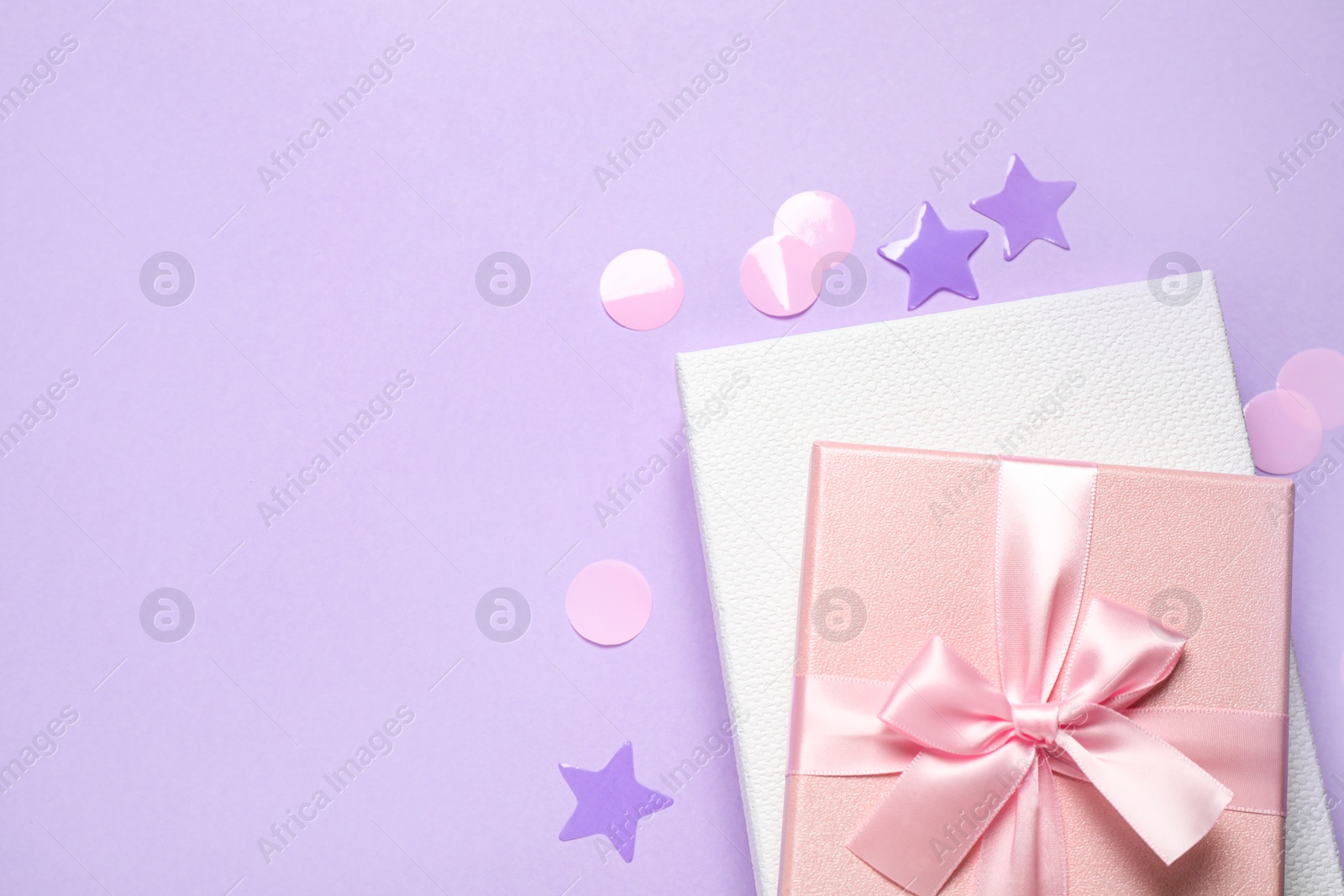 Photo of Beautiful gift boxes and confetti on violet background, flat lay. Space for text