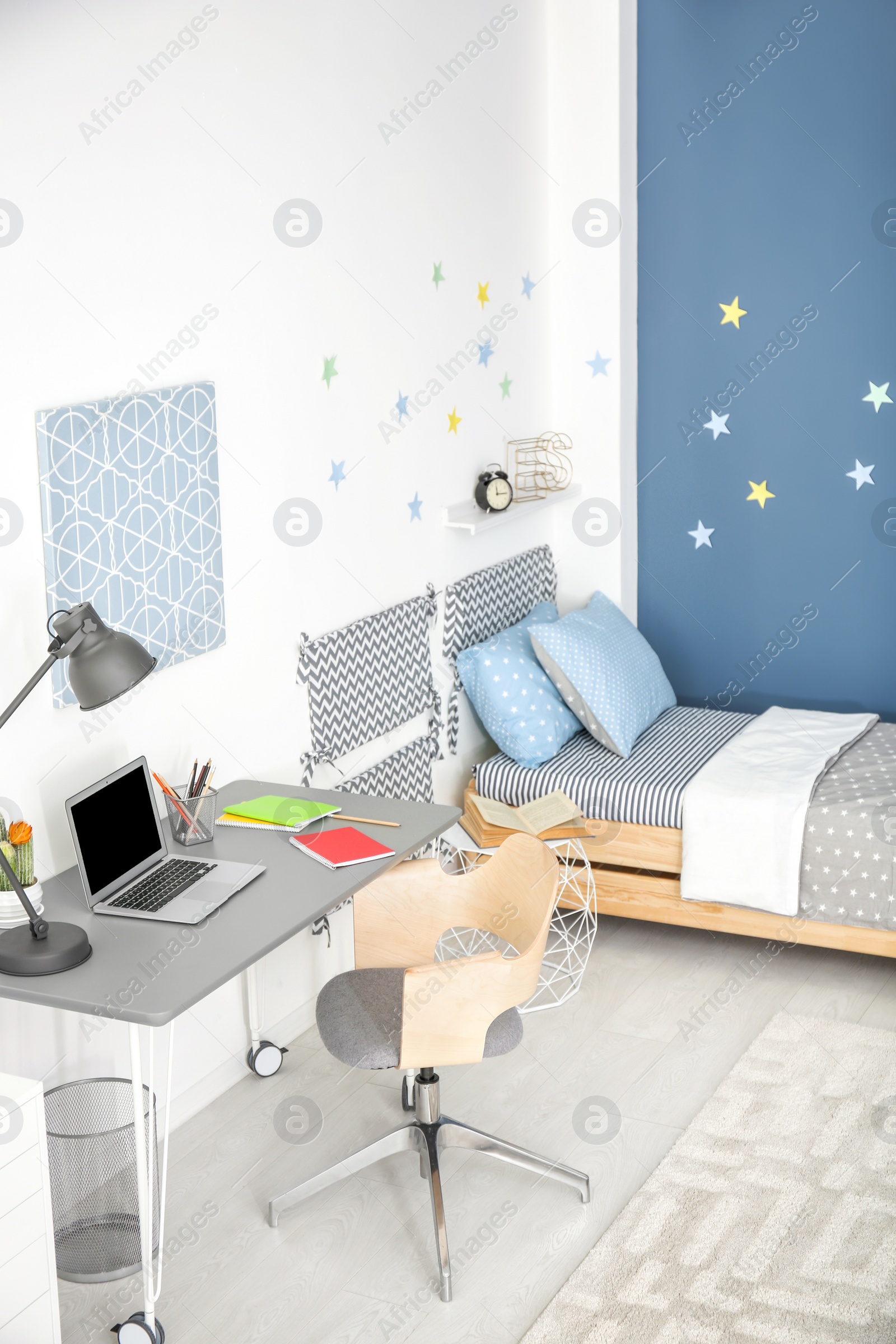 Photo of Modern child room interior with comfortable bed and desk