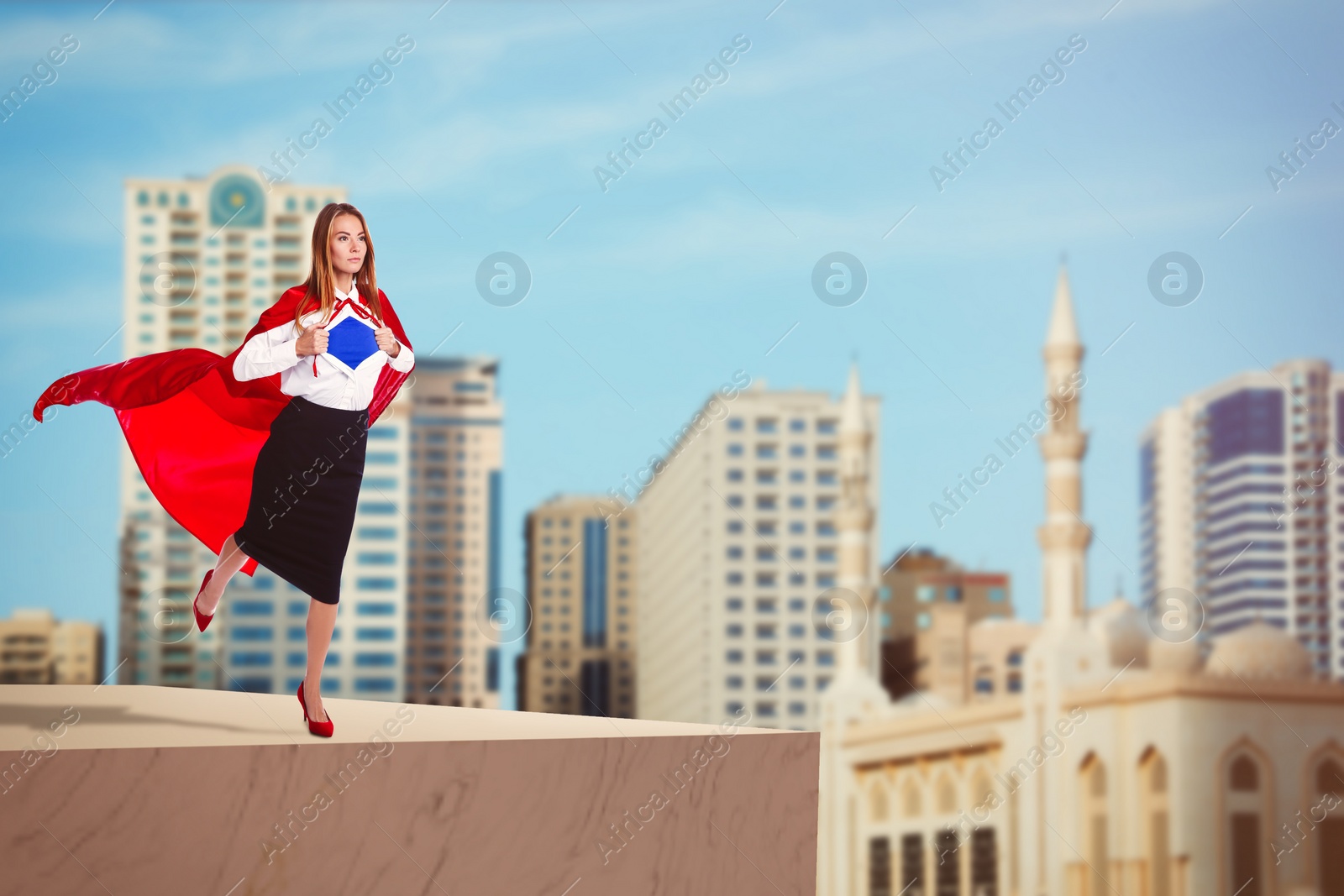 Image of Superhero, motivation and power. Woman in red cape on high building in city