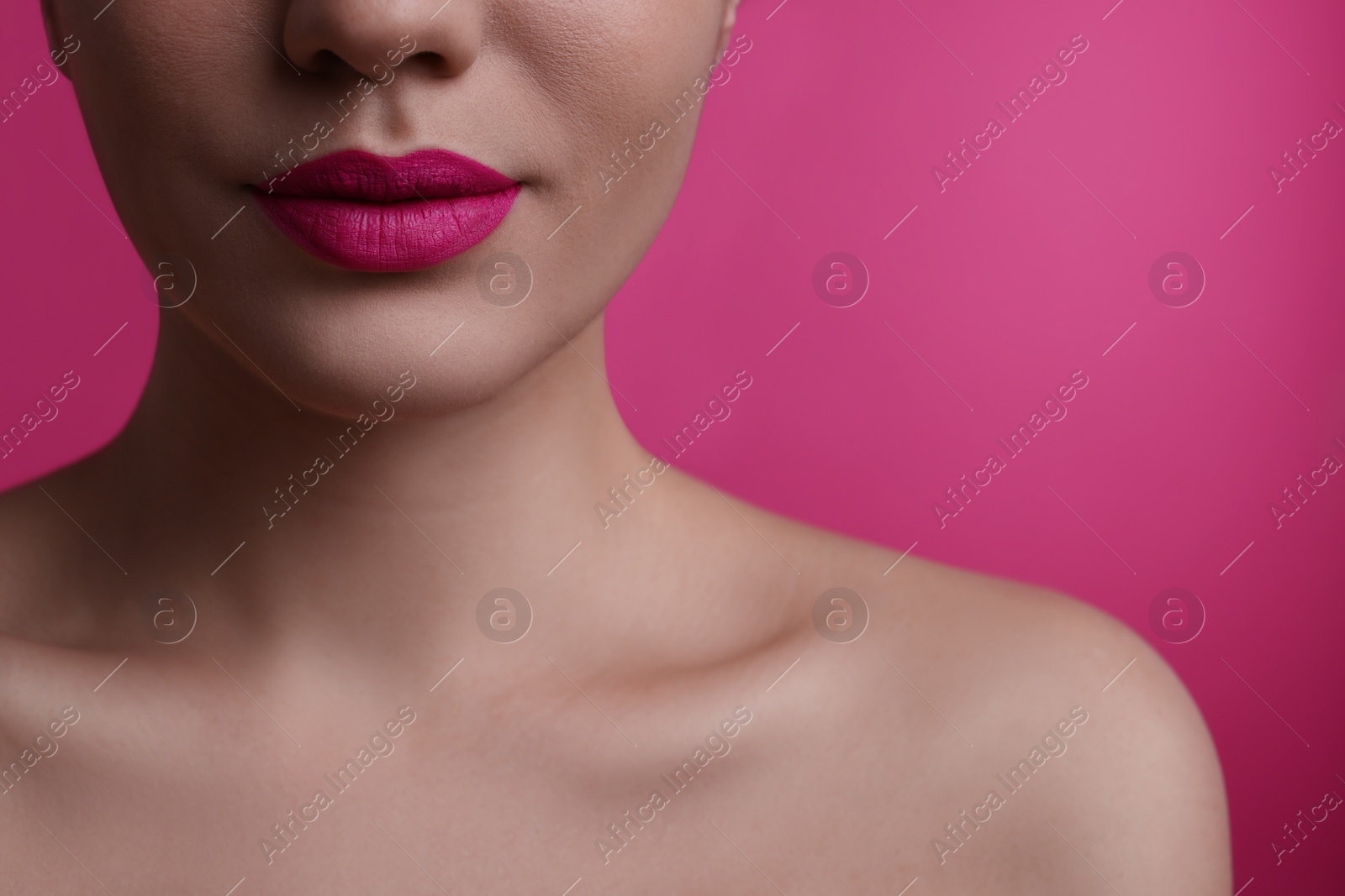 Photo of Closeup view of woman with beautiful full lips on pink background