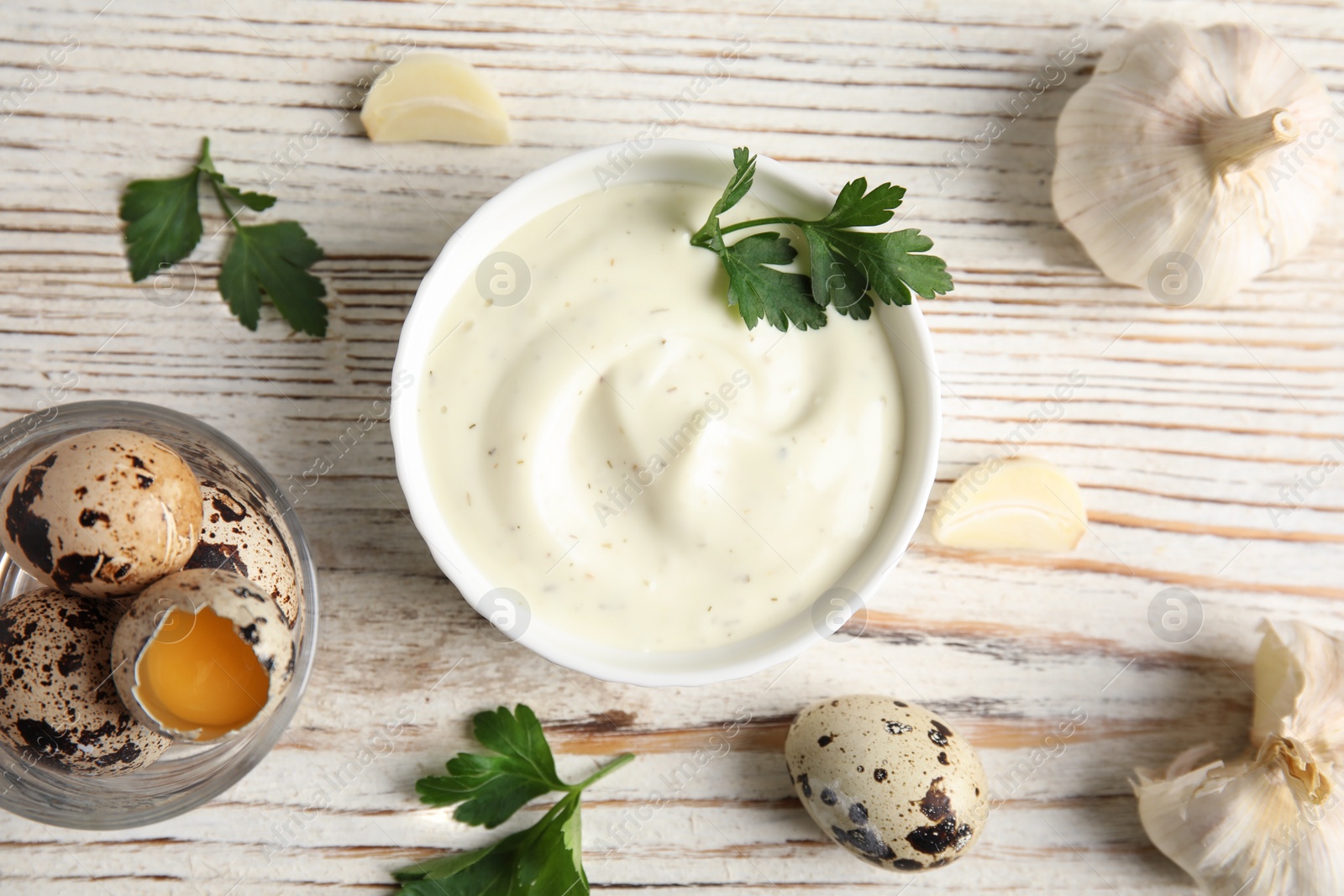 Photo of Flat lay composition with garlic sauce on wooden background