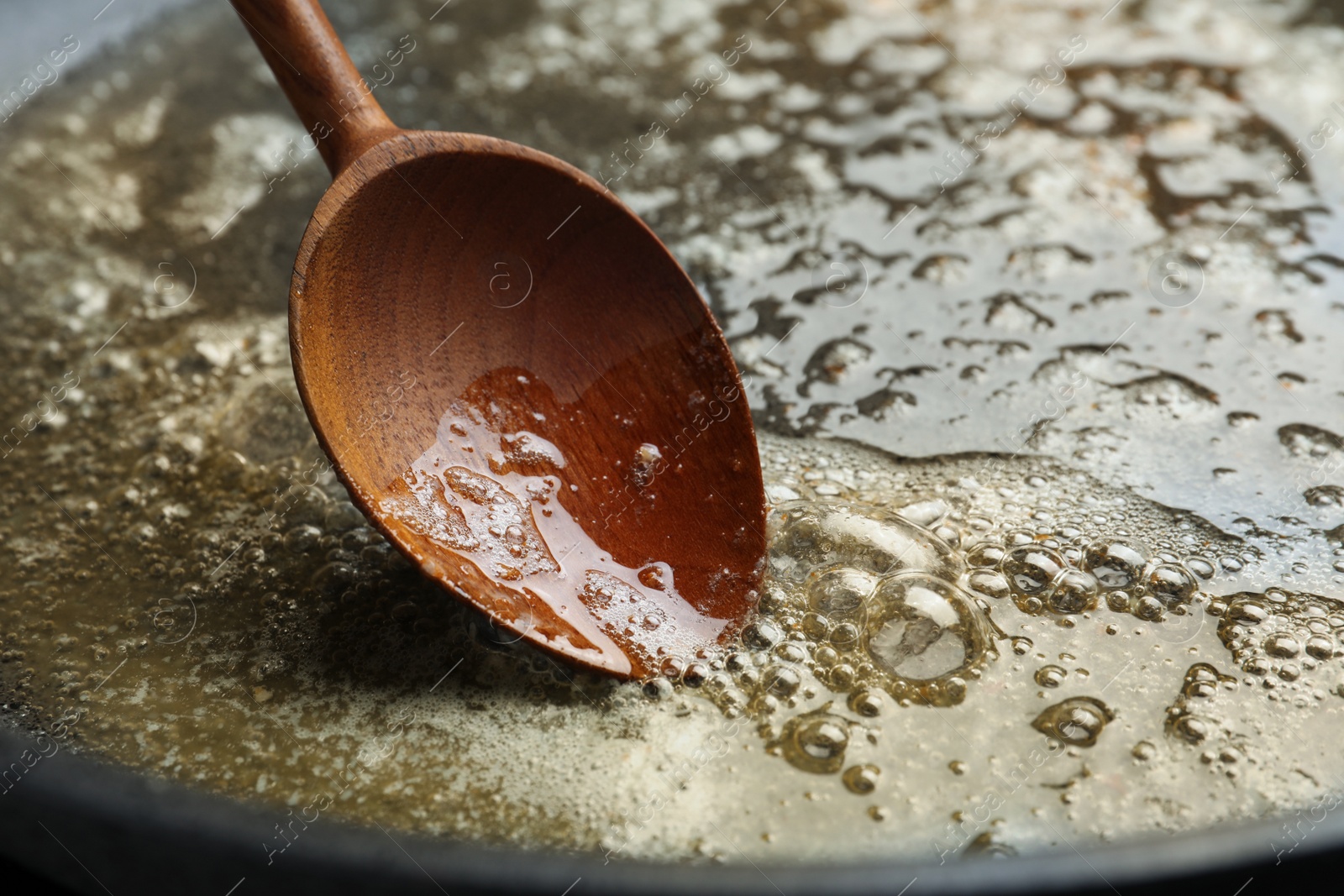 Photo of Melting butter in frying pan, closeup view