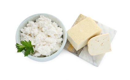 Photo of Different types of delicious tofu cheese with parsley on white background, above view