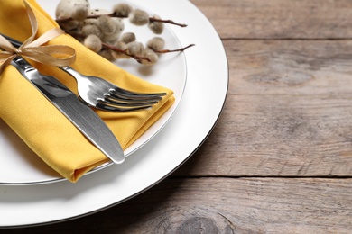 Festive Easter table setting on wooden background, closeup. Space for text