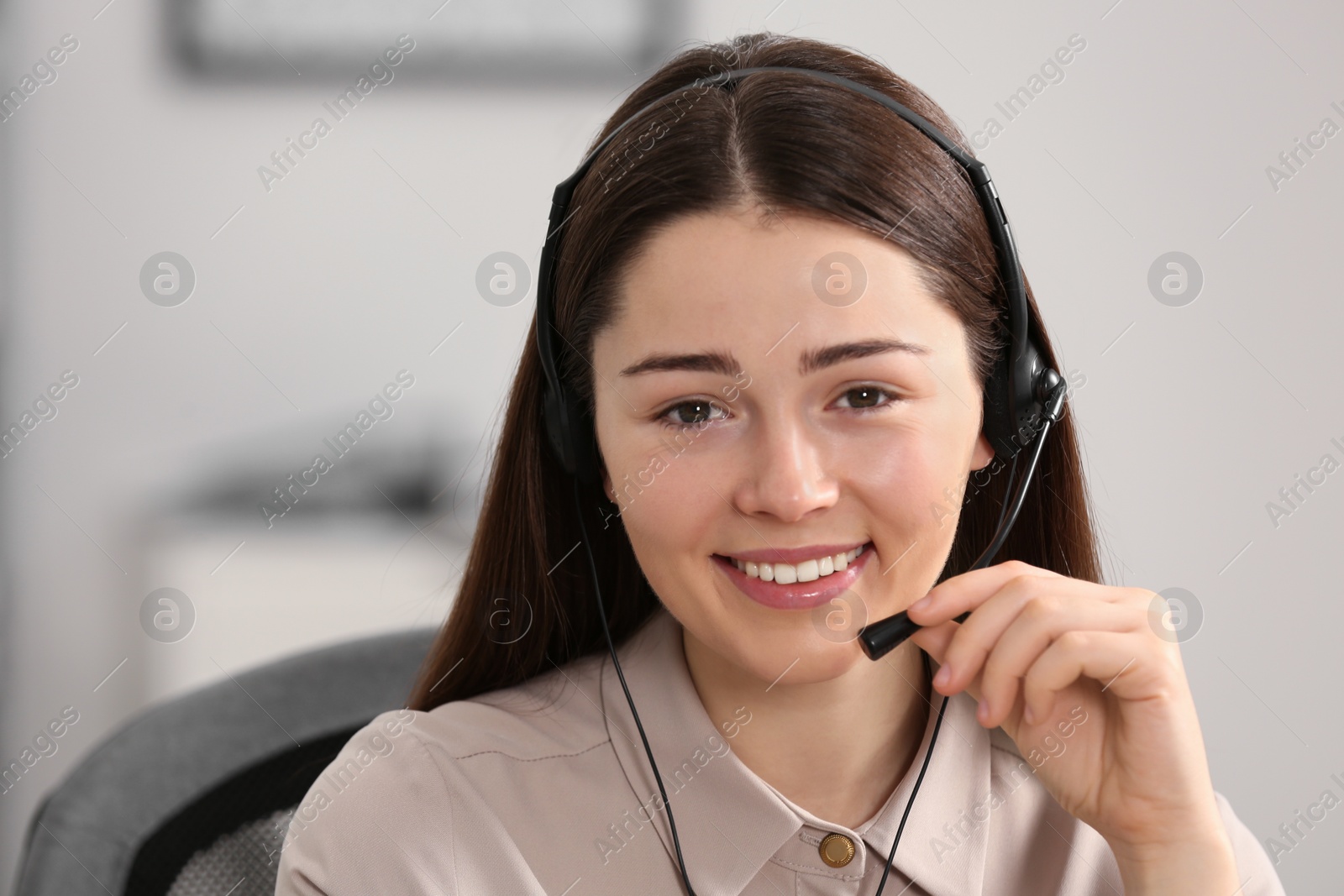 Photo of Hotline operator with headset working in office