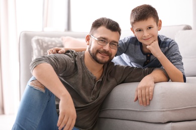 Little boy and his dad spending time together at home