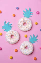 Photo of Fresh tasty donuts and candies on color background