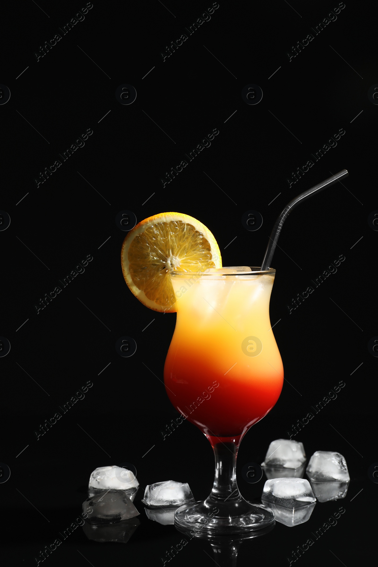 Photo of Just made appetizing cocktail Sex on the Beach, black background