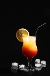 Photo of Just made appetizing cocktail Sex on the Beach, black background