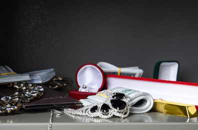 Photo of Open steel safe with money, gold bars and jewelry, closeup