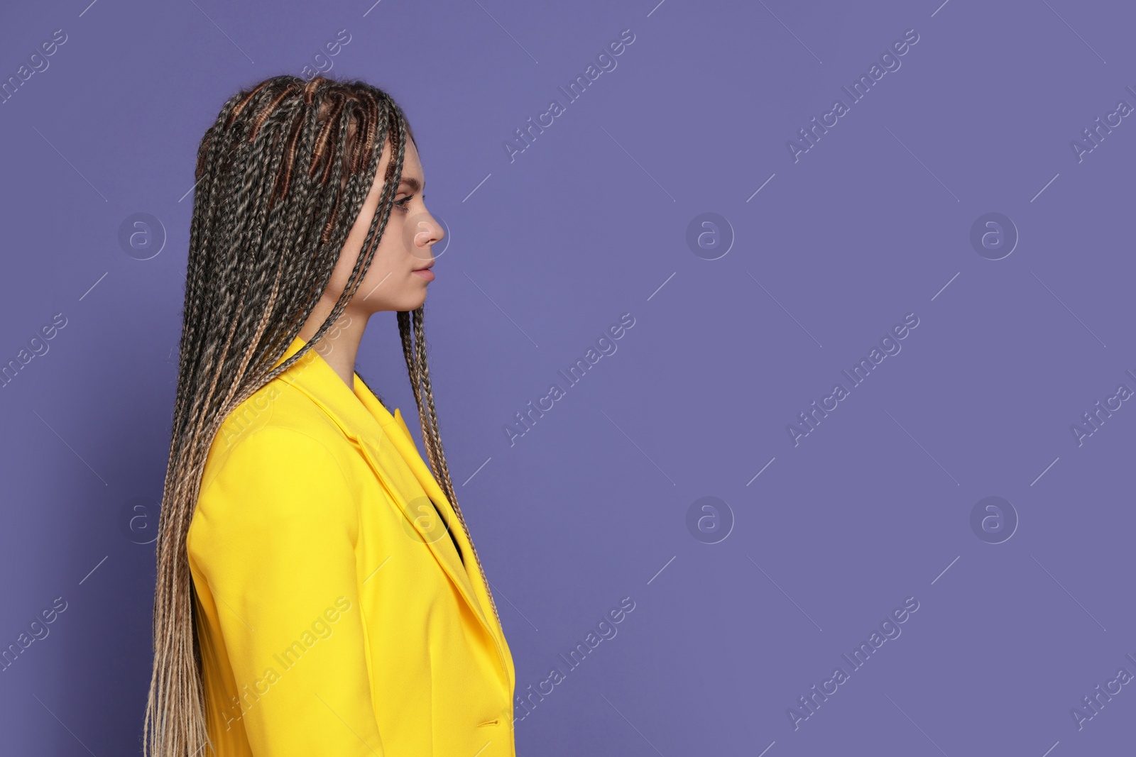 Photo of Beautiful woman with long african braids on purple background, space for text