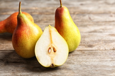 Ripe pears on wooden table. Space for text