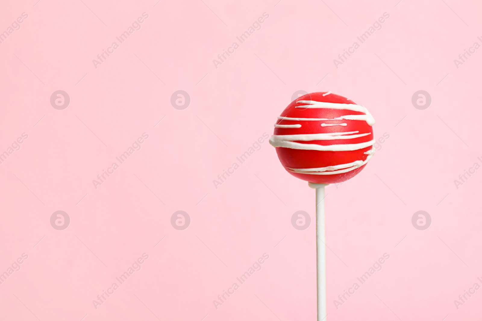 Photo of Bright delicious cake pop on color background. Space for text