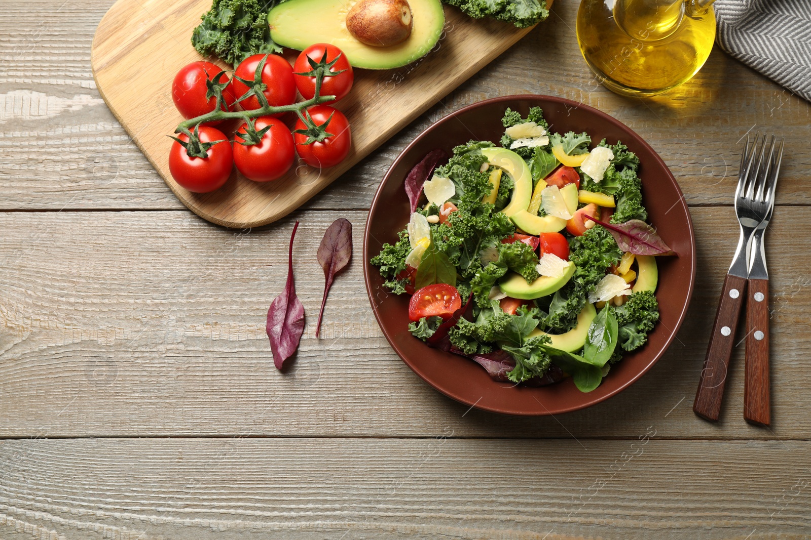 Photo of Tasty fresh kale salad on wooden table, flat lay