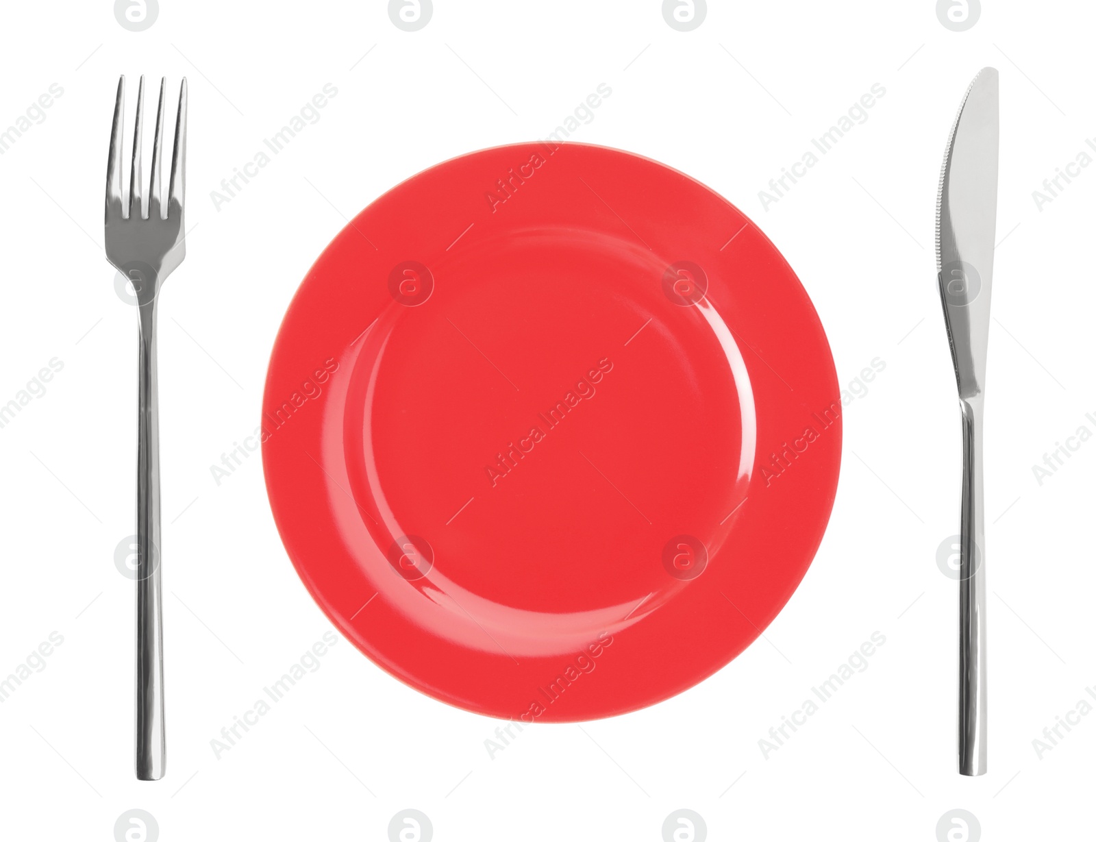 Image of Empty red plate with fork and knife on white background, top view