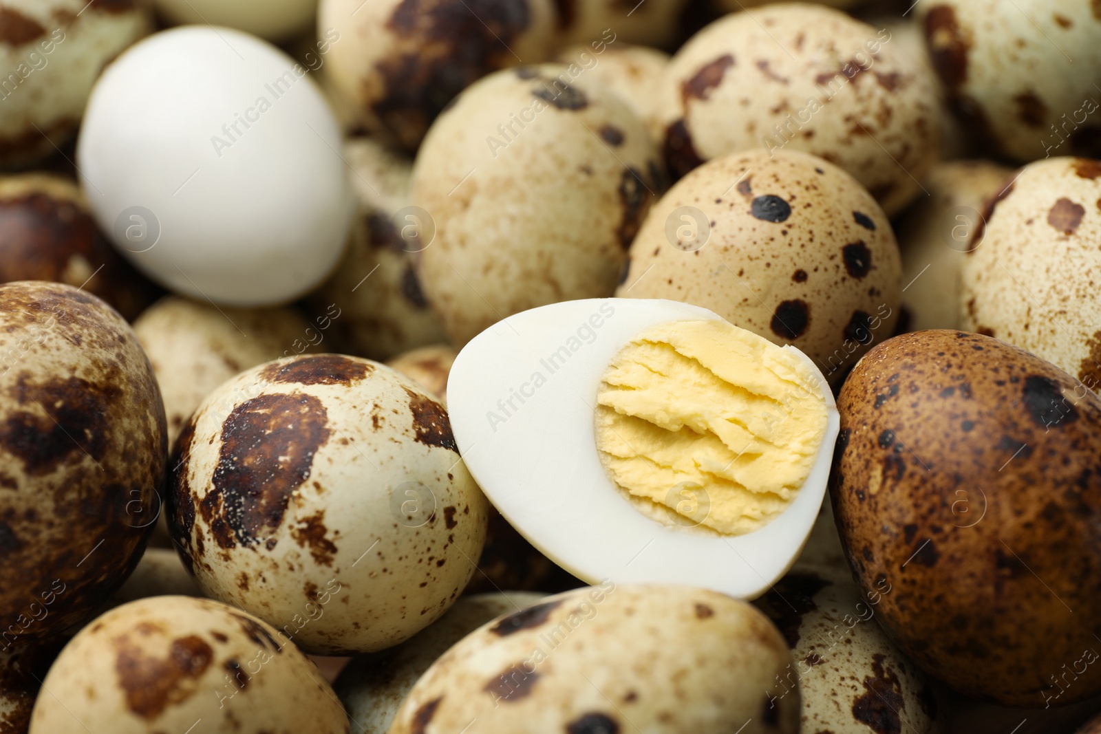 Photo of Heap of unpeeled and peeled hard boiled quail eggs as background, closeup