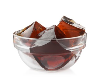 Photo of Delicious grass jelly cubes in glass bowl isolated on white