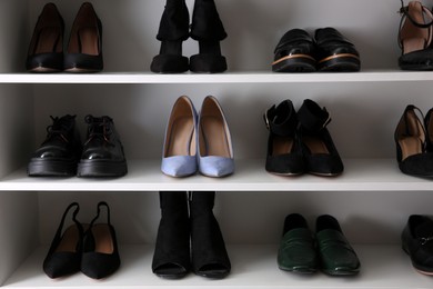 Blue shoes among others on shelving unit. Diversity concept