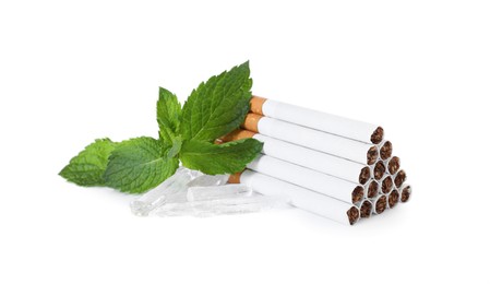 Photo of Cigarettes, menthol crystals and mint on white background
