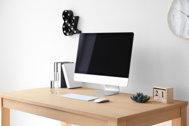 Comfortable workplace with computer on desk in home office