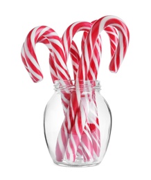 Photo of Glass with sweet Christmas candy canes on white background