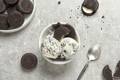 Flat lay composition with bowl of chocolate cookies ice cream on grey background