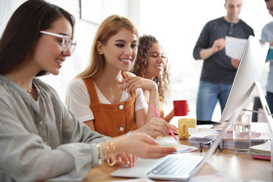 Photo of Team of professional designers working in office