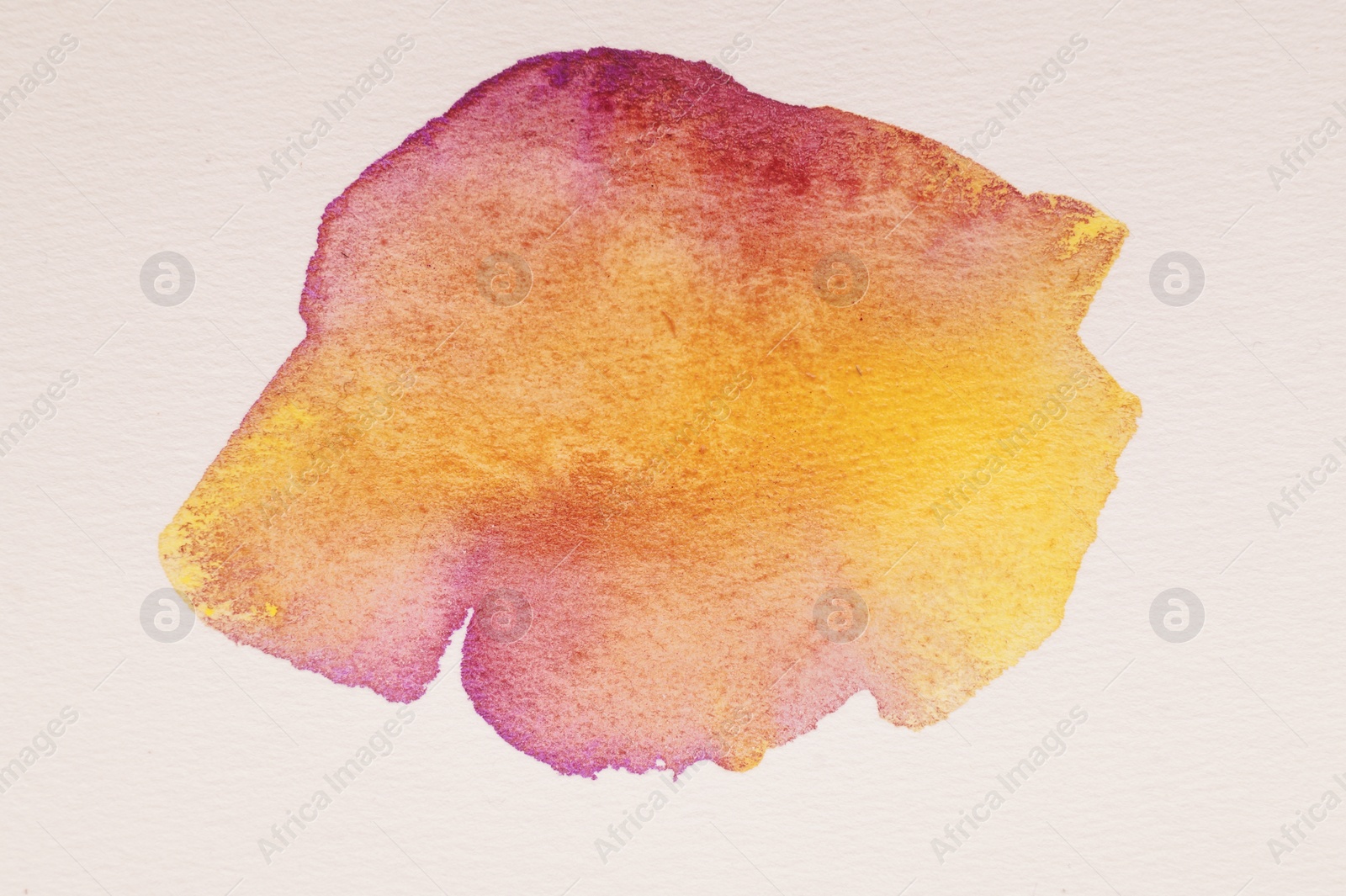 Photo of Blot of colorful watercolor paint on white paper, top view