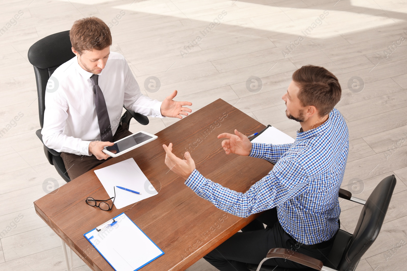 Photo of Human resources manager conducting job interview with applicant in office