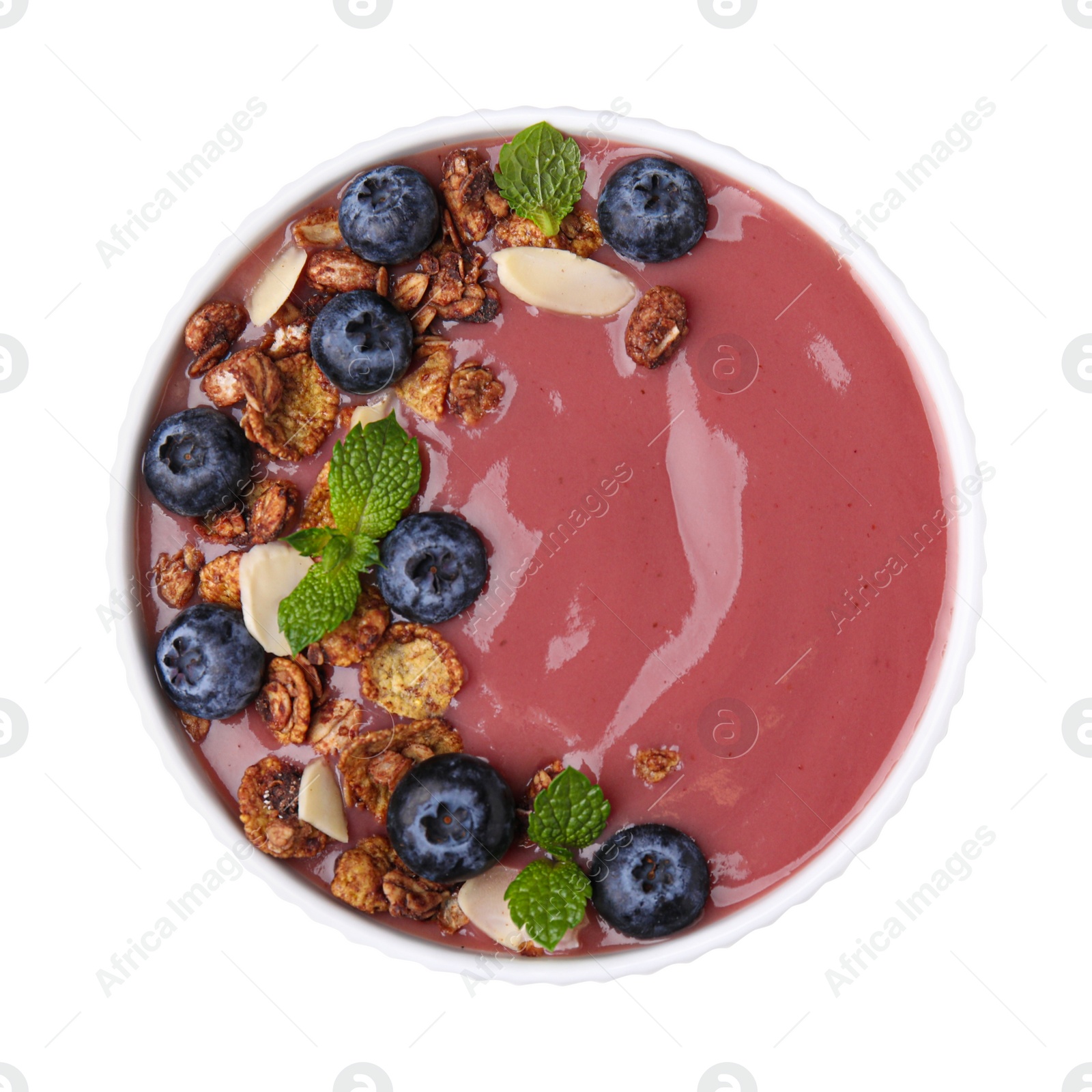 Photo of Bowl of delicious acai smoothie with fresh blueberries and granola isolated on white, top view