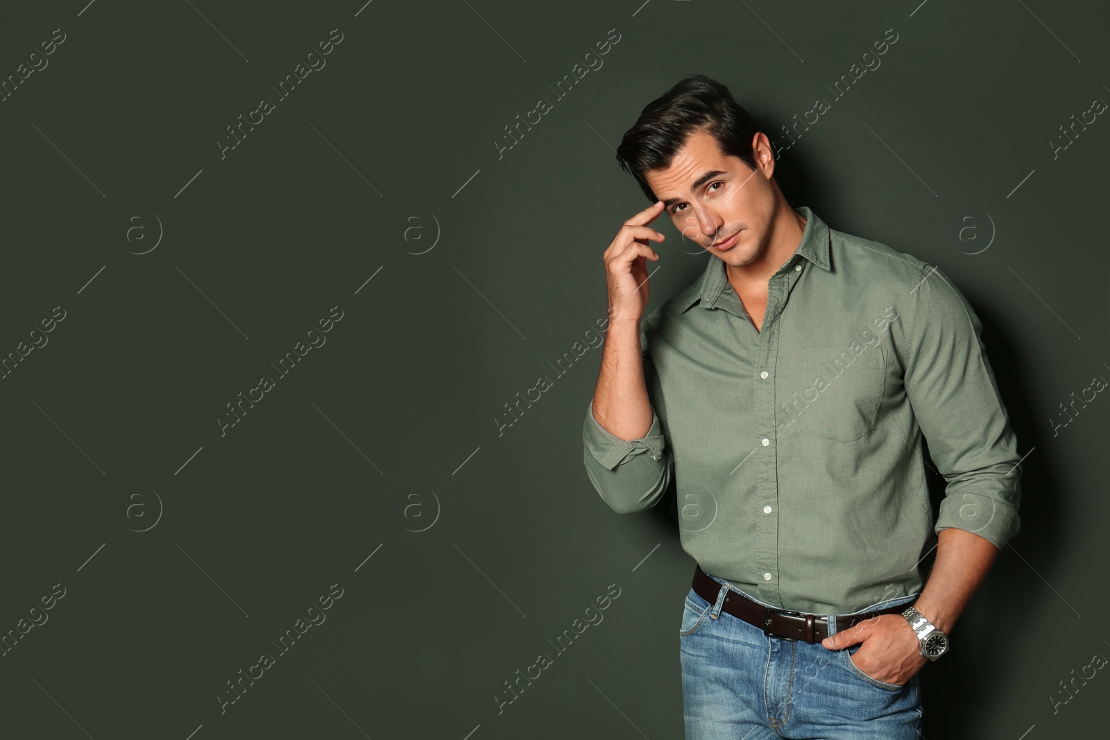 Photo of Handsome young man in stylish clothes on dark background. Space for text