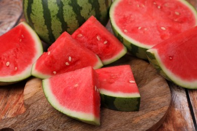 Pieces of juicy ripe watermelons on wooden table, closeup