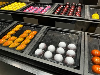 Photo of Showcase with different delicious desserts in store