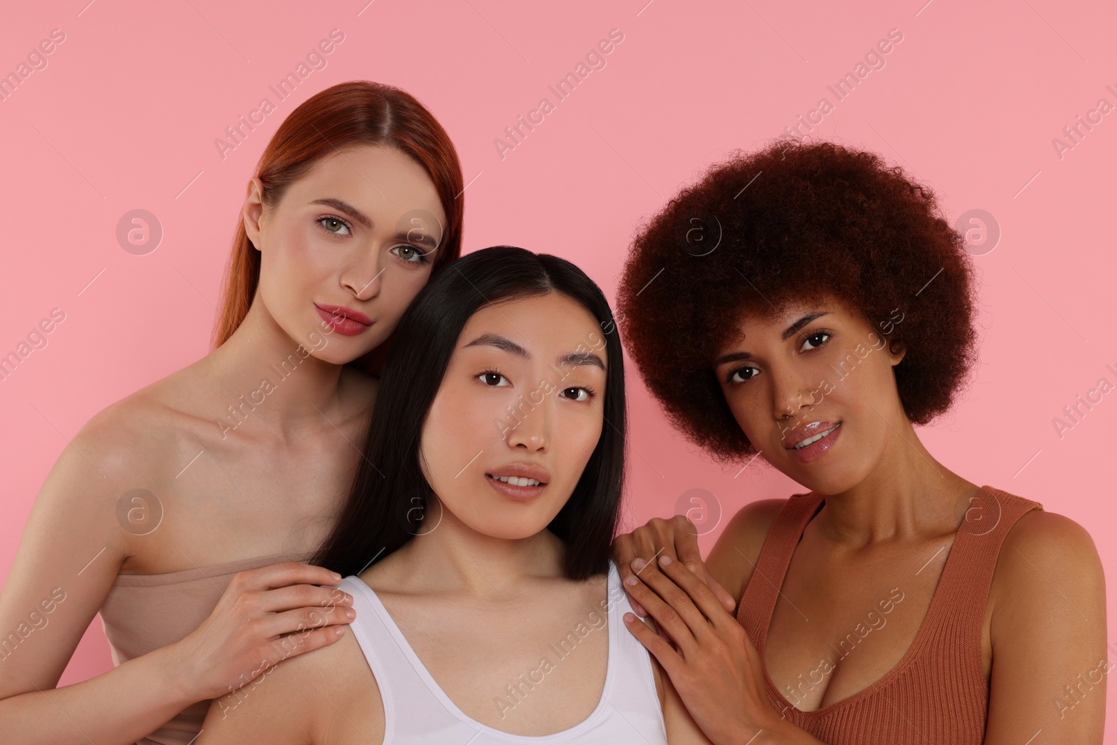 Photo of Portrait of beautiful young women on pink background