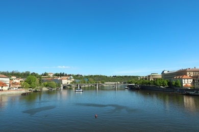 PRAGUE, CZECH REPUBLIC - APRIL 25, 2019: Cityscape with tourist attractions, Manes Bridge and Vltava river