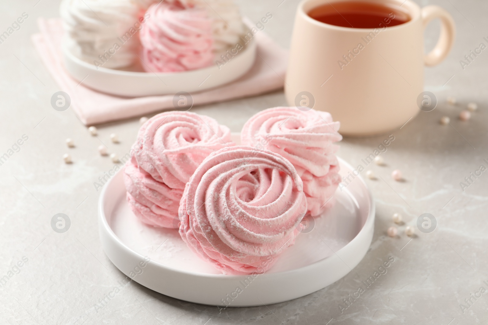 Photo of Delicious pink marshmallows on light grey table