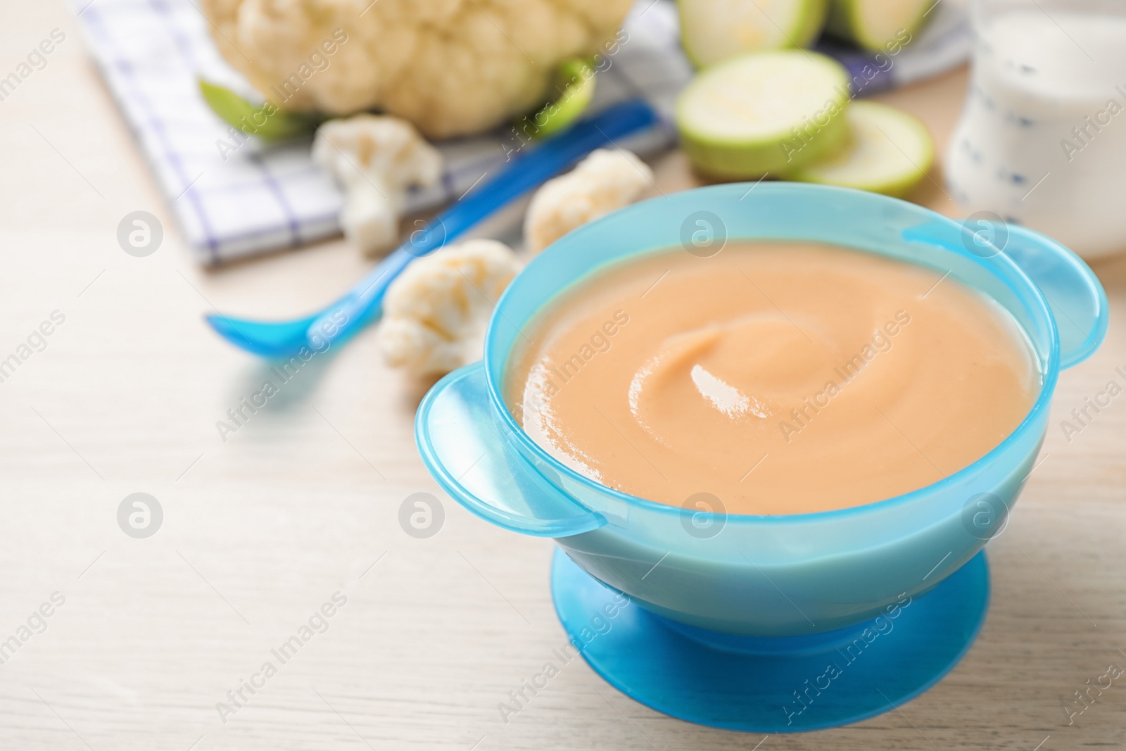 Photo of Healthy baby food on wooden table. Space for text