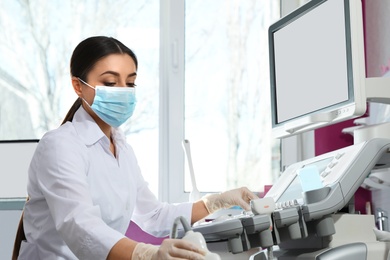 Sonographer using modern ultrasound machine in clinic