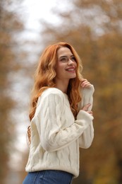 Photo of Autumn vibes. Portrait of smiling woman outdoors