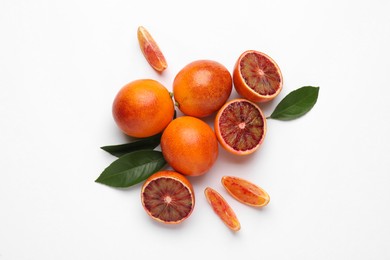 Photo of Ripe sicilian oranges and leaves on white background, flat lay