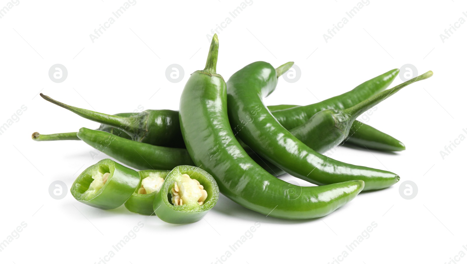 Photo of Cut and whole green hot chili peppers on white background