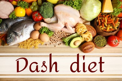 Dietary approaches to stop hypertension. Many different healthy food and words Dash diet on wooden table, flat lay